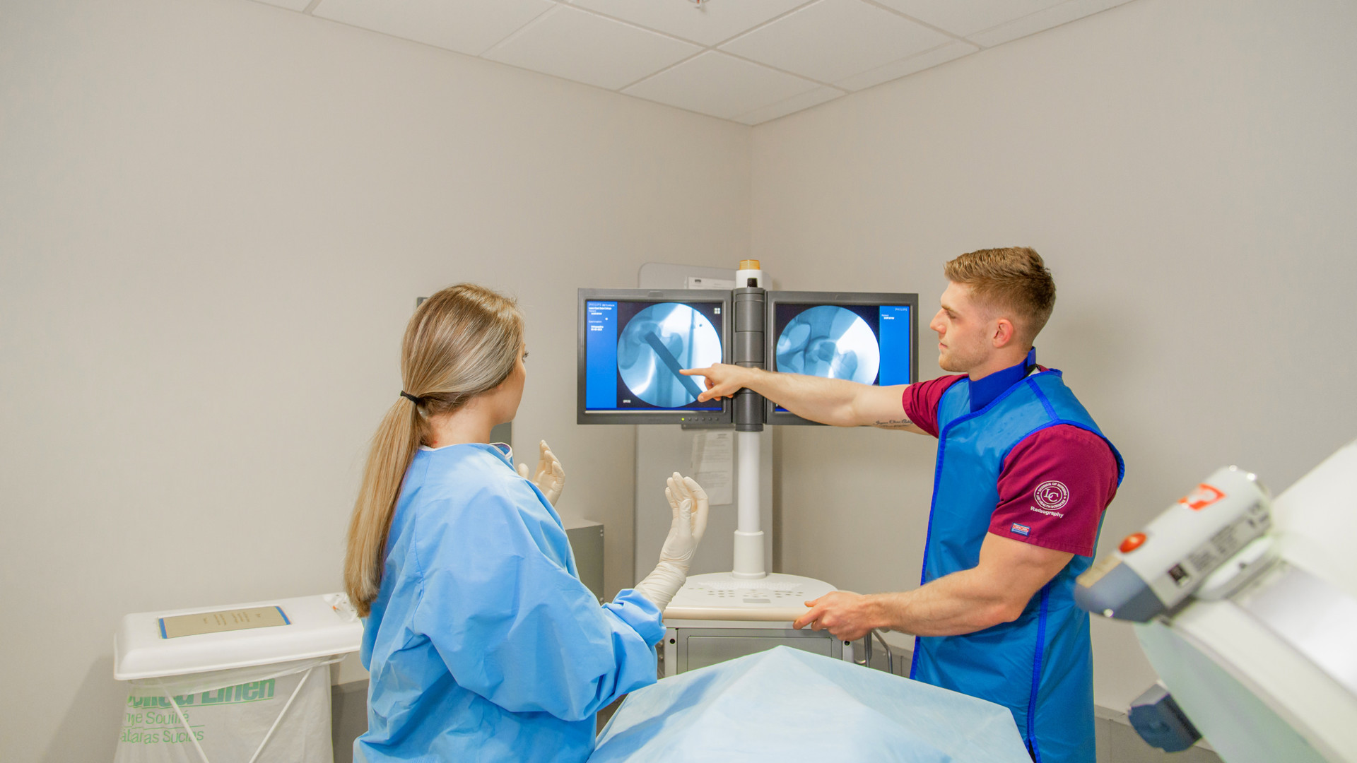 Two radiographic science students look at lab screen
